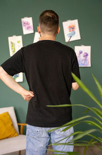 Side view of man using digital tablet while standing in office