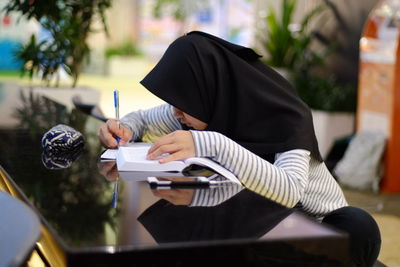 Close-up of woman studying