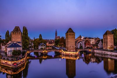 Reflection of illuminated buildings in city at night