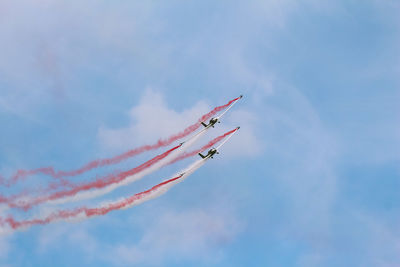 Low angle view of airplanes against sky