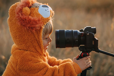 Side view of woman photographing camera