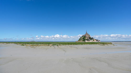 Panoramic view of beach against blue sky