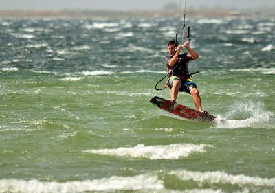Man kiteboarding in sea