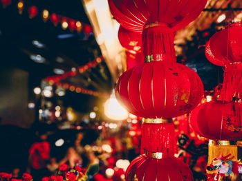 Close-up of illuminated lanterns hanging at night