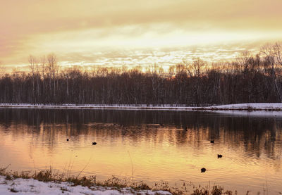 Scenic view of lake against sky during sunset