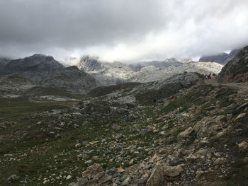 Scenic view of mountains against cloudy sky