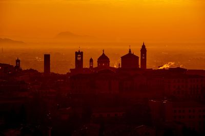 View of buildings in city during sunset