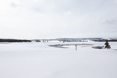 Scenic view of frozen lake against sky during winter