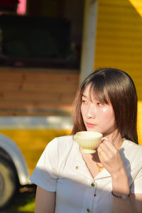 Portrait of smiling young woman looking away