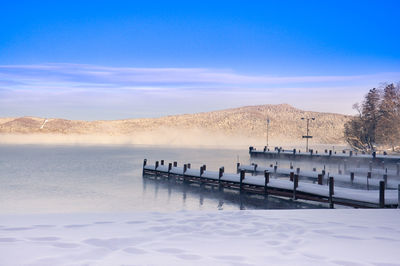 Scenic view of lake against sky during winter