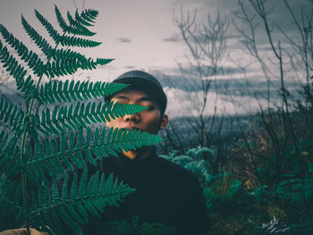 Portrait of man standing against plants