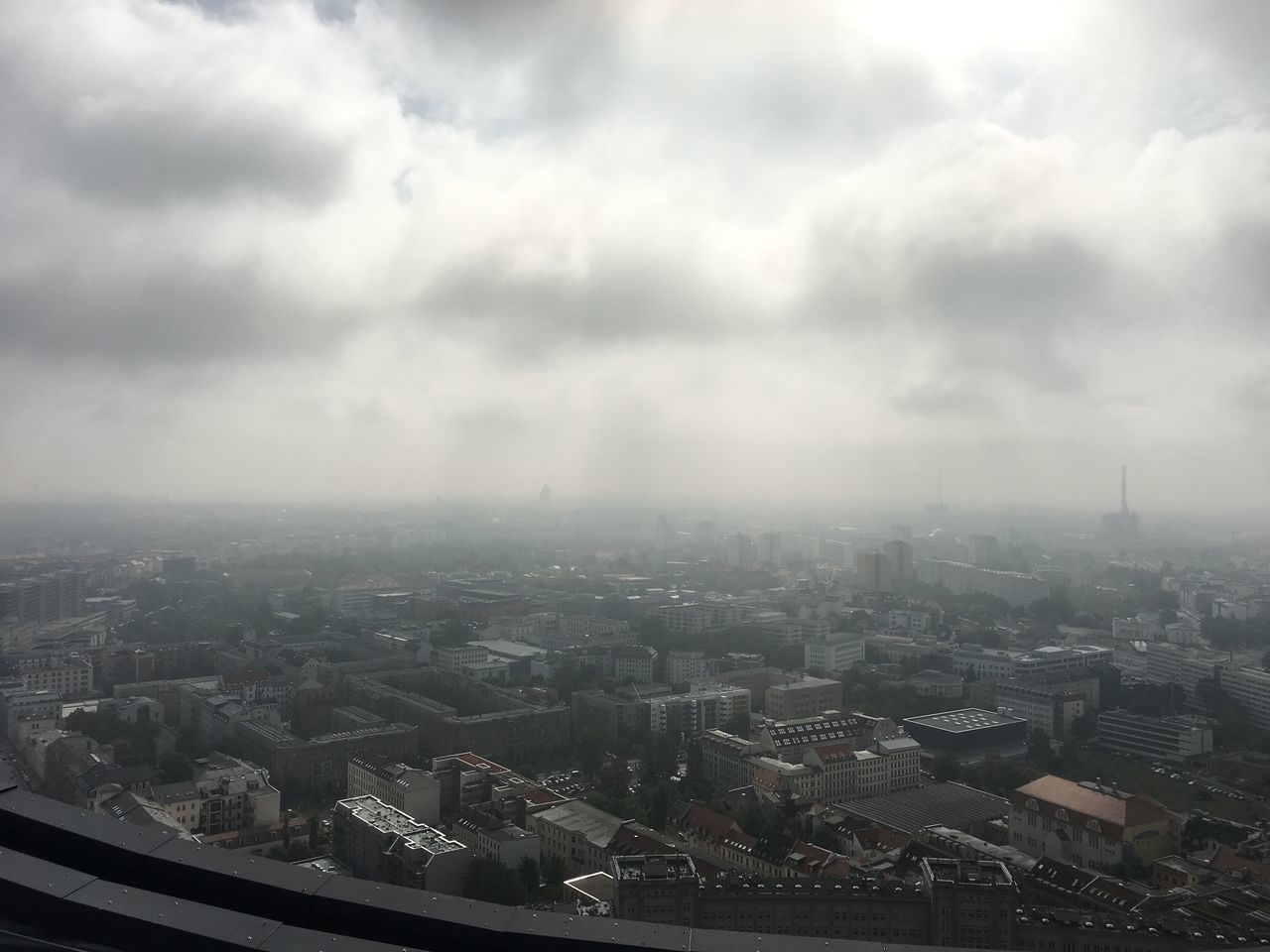 AERIAL VIEW OF CITY AGAINST STORM CLOUDS