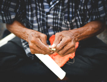 Close-up of man holding cigarette