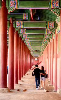 Rear view of people walking in building