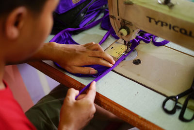 Midsection of man working on table
