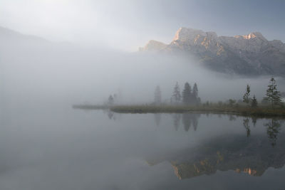 Scenic view of lake and mountains against sky