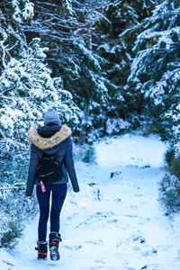 Full length rear view of woman in snow