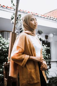 Low angle view of woman standing outdoors