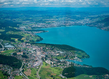 High angle view of townscape by sea against sky