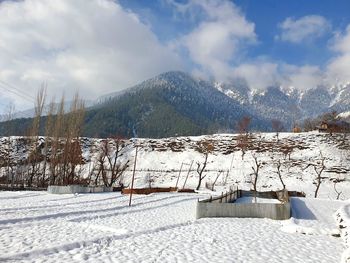 Scenic view of snow covered mountains against sky