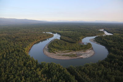 Aerial view of river in landscape against sky during sunset