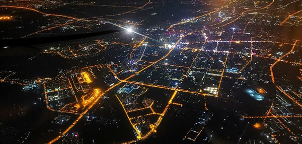 High angle view of illuminated buildings in city at night