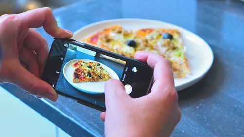 Midsection of person holding breakfast served in plate