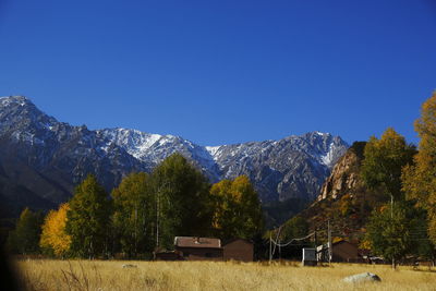 Scenic view of mountains against clear blue sky