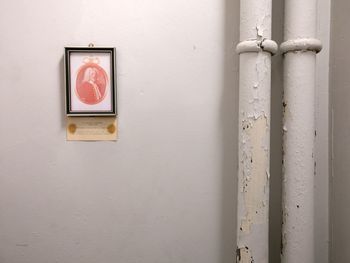 Close-up of telephone booth against wall