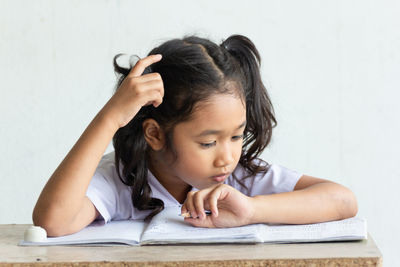 Cute girl studying at classroom