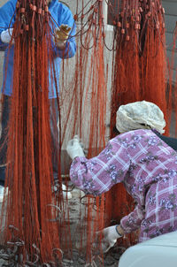 Two men arranging commercial net on street