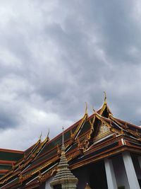 Low angle view of temple against cloudy sky