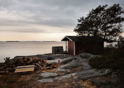 House or sauna by sea against sky in nature