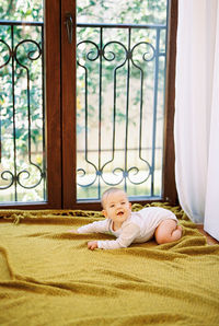 Portrait of cute girl sitting on floor at home