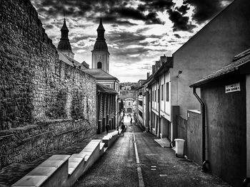 Empty alley amidst buildings in city