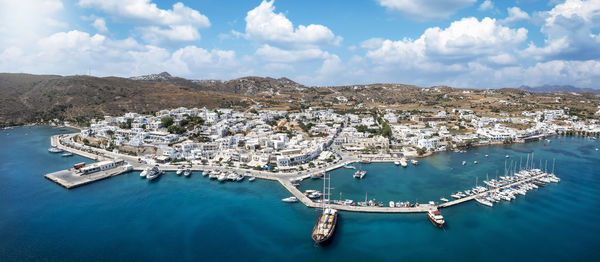 High angle view of townscape by sea against sky