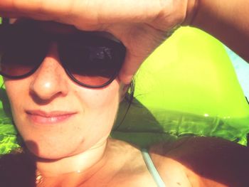 Close-up portrait of young woman wearing sunglasses