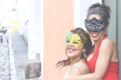 Portrait of two women wearing venice carnival mask. 