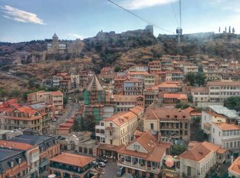 High angle view of town against cloudy sky