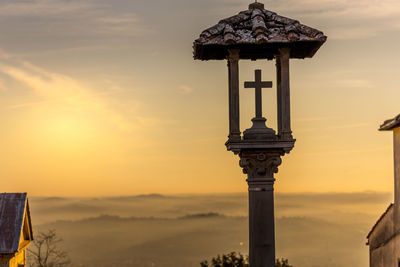 Cross against sky during sunset