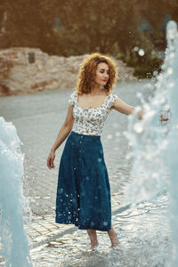 Full length of woman standing in water