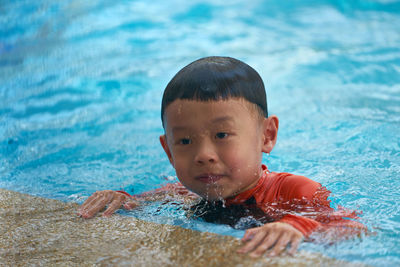 Boy swimming in pool