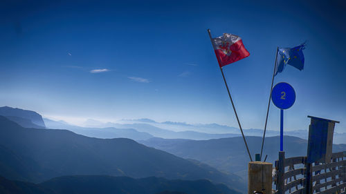 Flags on mountain against blue sky