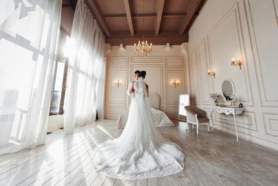 Rear view of woman standing on corridor in temple