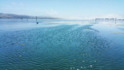 Misty blue. foggy day at the bay against rippling water.