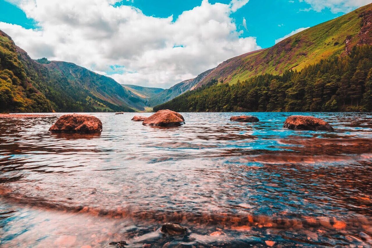 SCENIC VIEW OF LAKE BY MOUNTAIN AGAINST SKY