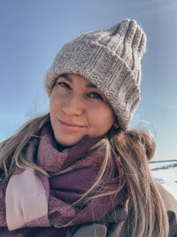 Portrait of woman standing against sky during winter