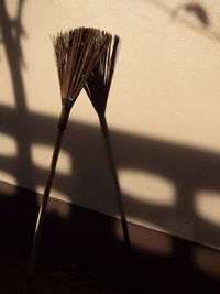 Close-up of umbrella on table against wall