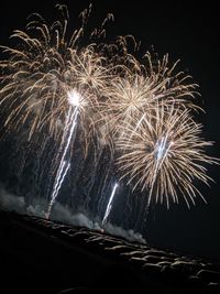 Low angle view of firework display at night