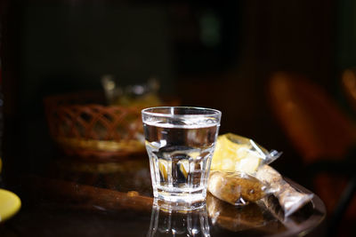 Glass with drinking water on the night cafe table